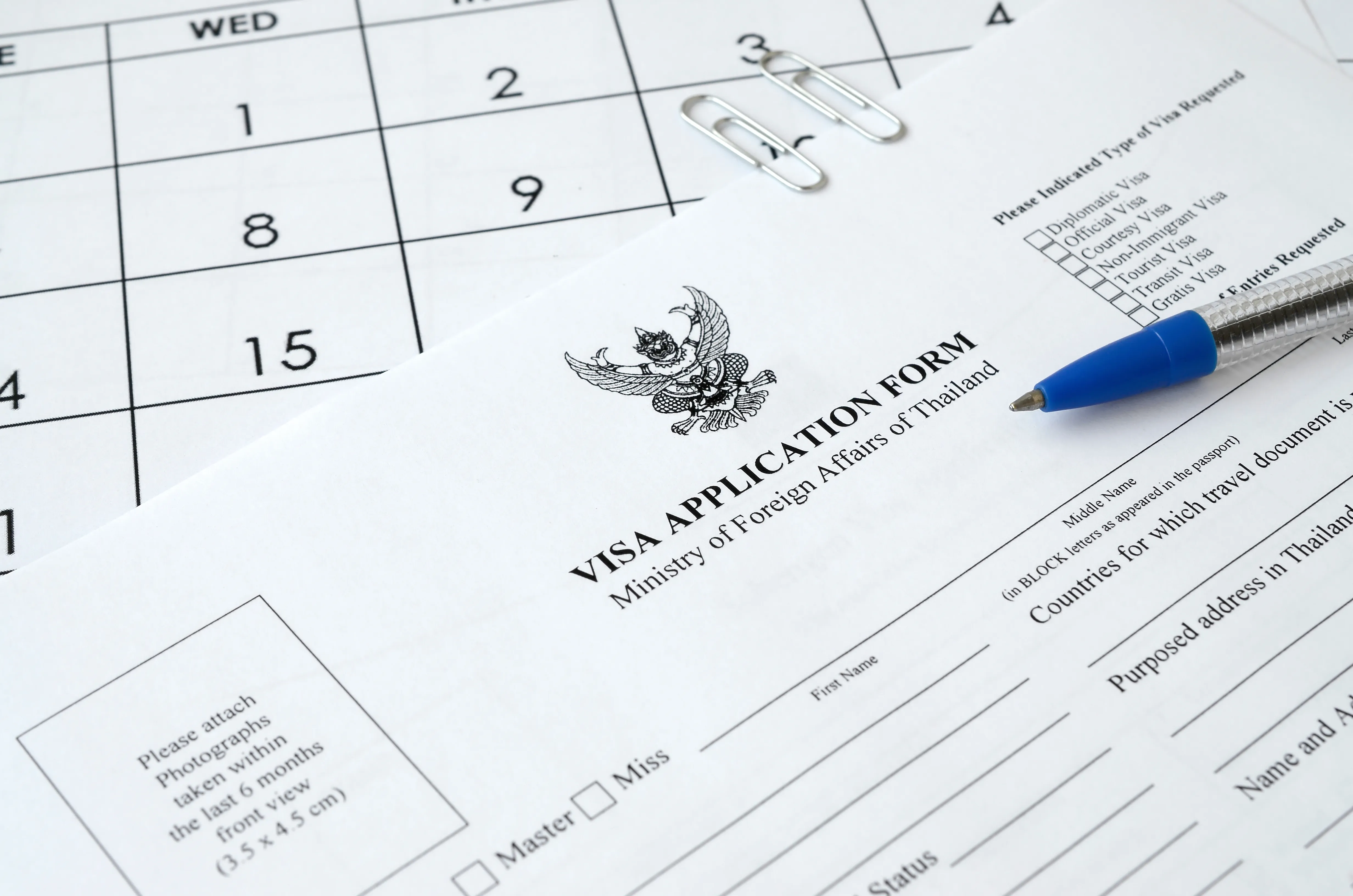 thailand visa application form and blue pen on paper